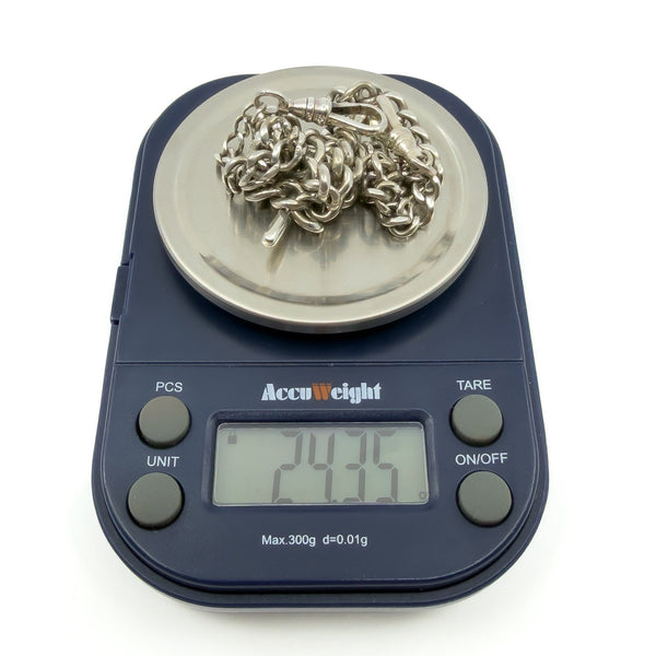 Antique sterling silver Albert chain shown on scales with weight reading approximately 24.35g.