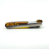 Side profile of amber and sterling silver pendant showing the long amber section.