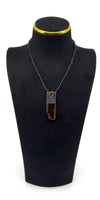 Amber and sterling silver pendant shown on a black display bust.