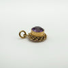Side profile of vintage amethyst charm showing gold rub over setting