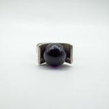 Close-up of amethyst ball set in modernist sterling silver ring