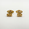 Backs of vintage gold stud earrings showing amethyst settings