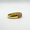 Gold-plated ruby ring showing transition from pavé section to polished band