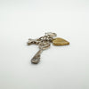 Angled view showing diamond cross, gold heart and heart-shaped key