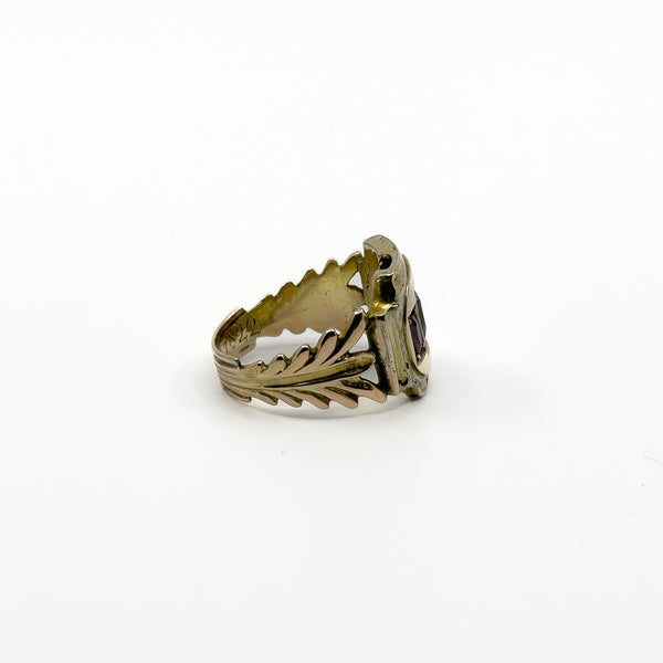 Angled view of antique Georgian amethyst trilogy ring with three oval cut stones in gold settings