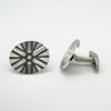 Angled view of both vintage cufflinks showing front detail and side profile