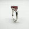 Angled shot highlighting ruby side stones and setting detail