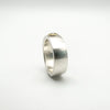 Angled view of CZ solitaire ring with gold bezel in matte silver band