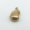 Side angled image of vintage 18ct gold kidney bean charm with curved surface