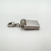 Side profile of sterling silver notebook charm with multi-page detail