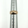 Antique 12ct rose gold band ring shown on a ring mandrel for sizing reference