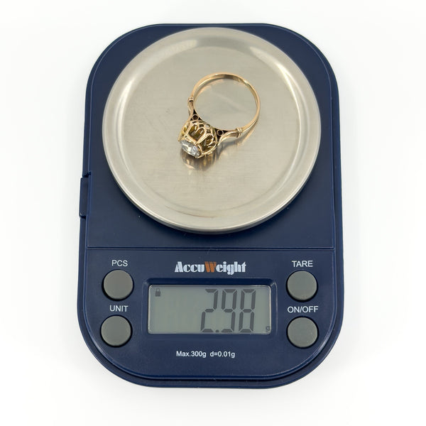 Antique rose gold rose-cut diamond solitaire ring shown on digital scales weighing approximately 2.98g.