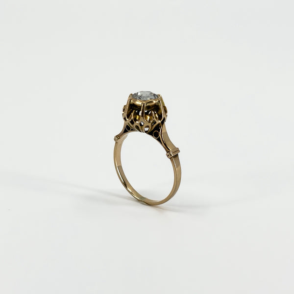 Angled upright view of the antique 14ct rose gold ring showing the height and decorative diamond setting.