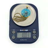 Victorian 18ct gold turquoise and rose-cut diamond tassel locket shown on scales weighing approximately 10.03g.