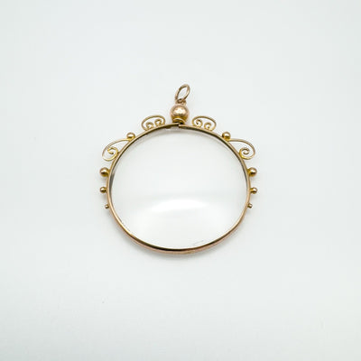 Antique 9ct gold glass locket pendant with scrollwork frame