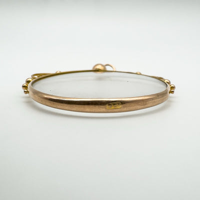 Thin side profile view of 9ct gold and glass locket