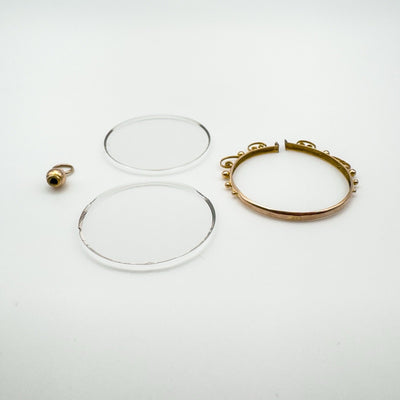 Dismantled antique gold locket showing construction detail