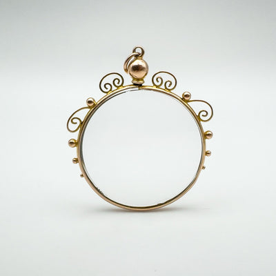 Front view of antique locket pendant in 9ct gold with glass inserts fully assembled.