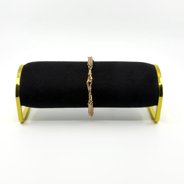 Antique 9ct rose gold fancy link bracelet displayed on a black bracelet stand