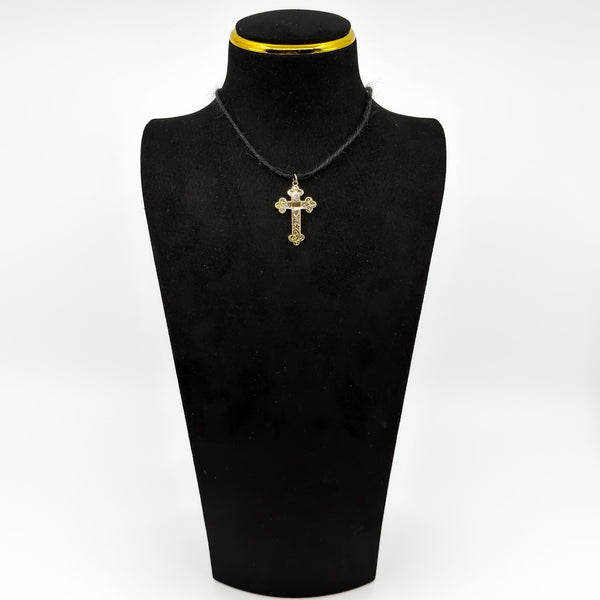Antique 9ct rose gold engraved cross pendant shown on a black cord for styling