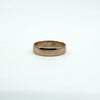 Side angle showing band thickness and gentle curve of a Victorian rose gold ring.