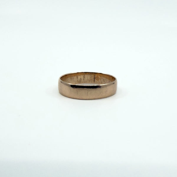 Side angle showing band thickness and gentle curve of a Victorian rose gold ring.