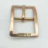 Angled close-up of antique gold buckle charm with hallmarks for London 1913