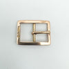Close-up of antique rose gold buckle charm showing 1913 hallmarks and smooth frame