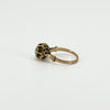Side detail of the antique rose gold ring showing the decorative openwork around the rose-cut diamond setting.