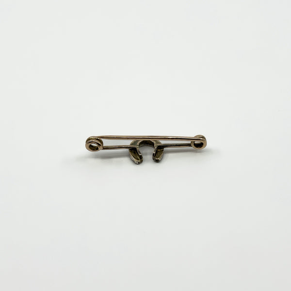 Reverse of antique 9ct gold horseshoe bar brooch showing pin and hook fitting