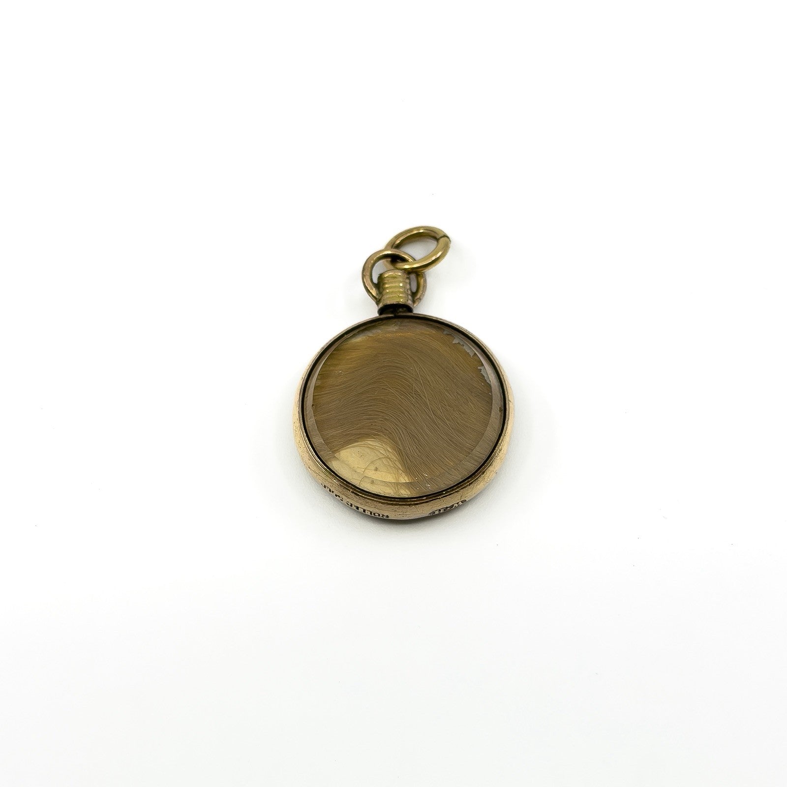 Antique rolled gold double sided glass locket showing the original lock of blonde hair inside