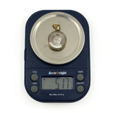 Antique rolled gold double sided glass photo locket shown on scales weighing approximately 5.1g