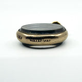 Close view of antique rolled gold photo locket with ROLLED GOLD stamp on the edge