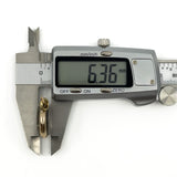 Side measurement of antique rolled gold double sided glass photo locket showing approximately 6.3mm depth
