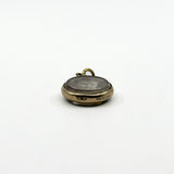 Antique rolled gold double sided photo locket with edge stamp and original portrait visible through glass