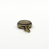 Side view of antique rolled gold glass photo locket showing the unscrew bail opening detail