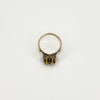 View from above of the antique rose gold ring showing the decorative setting beneath the rose-cut diamond.