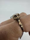 Antique 14ct rose gold rose-cut diamond ring worn on the finger, showing the raised setting and shoulder detail.