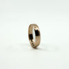Low profile view of a Victorian rose gold full band ring against a white background.