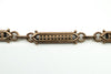 Close up of the 9c mark on the dog clip of an antique rose gold bracelet