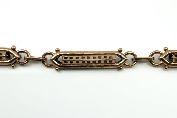 Close up of the 9c mark on the dog clip of an antique rose gold bracelet