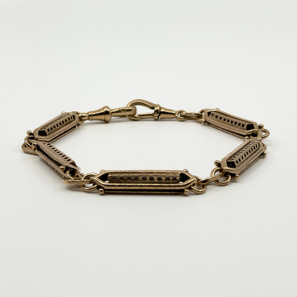 Antique rose gold bracelet showing shaped fancy links and double dog clip closure