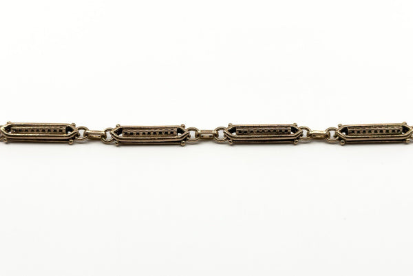 Close up of antique rose gold bracelet links with ornate shaped fancy link detail