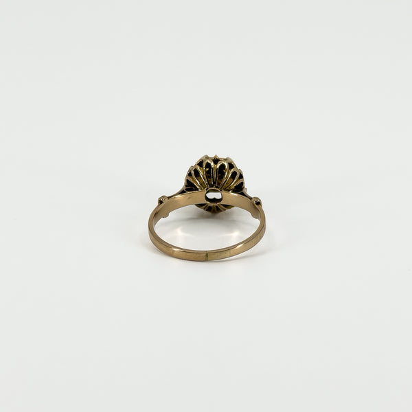 Underside view of the antique rose gold solitaire ring showing the band and decorative back of the diamond setting.