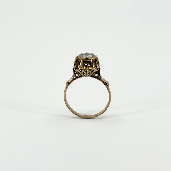 Full side profile of the antique rose gold ring showing the raised rose-cut diamond and decorative openwork setting.