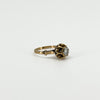 Three-quarter view of antique 14ct rose gold solitaire ring showing the rose-cut diamond and ornate setting.