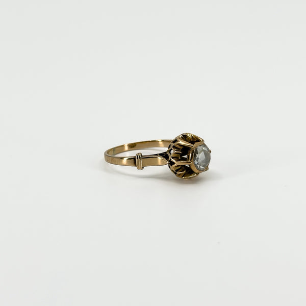 Three-quarter view of antique 14ct rose gold solitaire ring showing the rose-cut diamond and ornate setting.