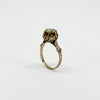 Upright profile of the antique 14ct rose gold ring showing the raised rose-cut diamond setting and shoulders.