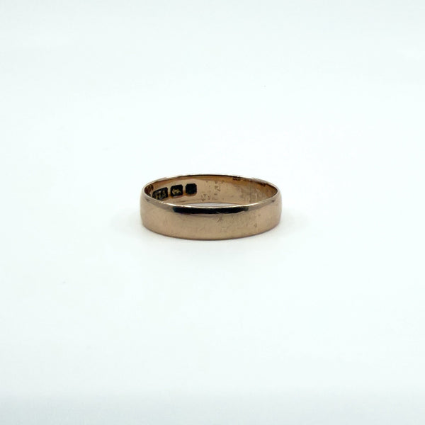 Antique 9ct rose gold band ring with partial Birmingham hallmarks visible inside the band