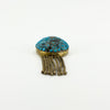 Low front view of Victorian 18ct gold locket showing the turquoise-set dome and articulated gold tassels.